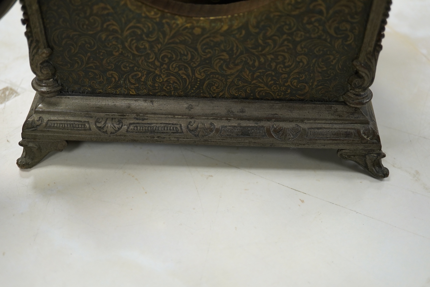 A brass overlaid mantel clock with key and pendulum, striking on a bell, 26cm high